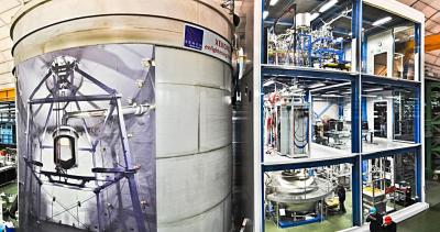 XENON1T installation in the underground hall of Laboratori Nazionali del Gran Sasso. The three story building on the right houses various auxiliary systems. The cryostat containing the LXeTPC is located inside the large water tank on the left. <i>Photo by Roberto Corrieri and Patrick De Perio</i>