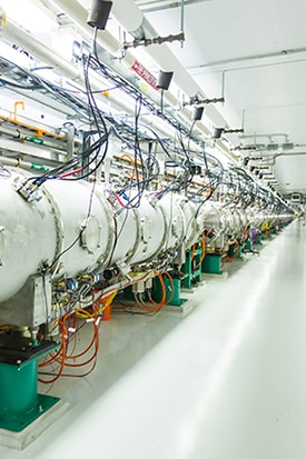 SNSs Beamline 13, which carries neutrons from the SNS collider to experimental stations. The same process that produces the neutrons also spits out neutrinos, which enter the COHERENT detector in the SNS basement.  <i>Credit: Jean Lachat University of Chicago.</i>