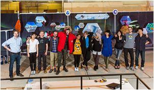 Bo Rodda (far left), and members of his Manifest SPACE class at the School of the Art Institute Chicago gather in front of the South Pole Telescope exhibit, which they produced as a class project.