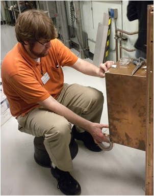 Chris Williams assembling the MAYBE chamber at the Argonne National Laboratory Van de Graaff electron accelerator.